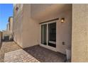 Small paved patio area with sliding glass door access at 6952 Crescent Gold St, North Las Vegas, NV 89086