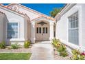 Elegant entryway with double doors, light fixture, and landscaping at 7436 Silent Sage Dr, Las Vegas, NV 89149