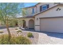 Two-story house with a neutral color scheme and a landscaped front yard at 8753 Vermont Vista St, Las Vegas, NV 89113