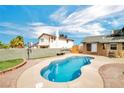 Inviting kidney shaped pool in a backyard oasis at 6373 Enchanting Ct, Las Vegas, NV 89156