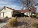 Front view of house with walkway, landscaping, and three-car garage at 8608 Alfano Ct, Las Vegas, NV 89117