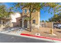 Two-story house with tan siding, attached garage, and fire hydrant visible at 1306 Plum Canyon St, Las Vegas, NV 89142