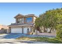 Two-story house with a three-car garage and mature trees at 2120 Interbay St, Las Vegas, NV 89128