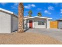 Newly remodeled home with red door and landscaped yard at 4306 Swandale Ave, Las Vegas, NV 89121