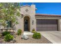 Single-story home with Spanish-style architecture, two-car garage, and landscaped front yard at 5658 Pleasant Palms St, North Las Vegas, NV 89081