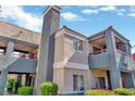 Two-story apartment building with gray siding, red accents, and balconies at 8600 W Charleston Blvd # 2092, Las Vegas, NV 89117