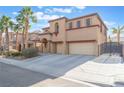 Two-story house with attached garage and palm trees at , North Las Vegas, NV 89031