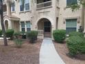 Condo building exterior showing entrance and landscaping at 10550 W Alexander Rd # 1032, Las Vegas, NV 89129