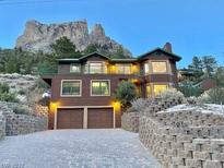 Two-story home with mountain backdrop at dusk at 356 Crestview Dr, Mount Charleston, NV 89124