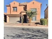 Two-story house with tan exterior and palm tree at 4128 Bennett Mountain St, Las Vegas, NV 89129