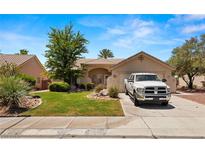 Single story home with landscaping, driveway and a truck parked in front at 435 Glade Rd, Mesquite, NV 89027