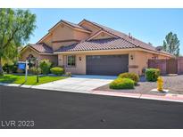 Two story home with a two car garage and landscaped yard at 9081 Herrera Ave, Las Vegas, NV 89129