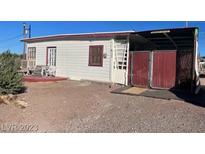 Older home with carport and fenced yard at 203 W Pacific Ave, Henderson, NV 89015