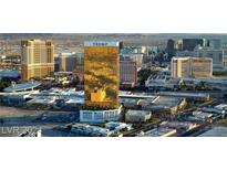 Aerial view of a high rise building in a city with surrounding buildings and mountains at 2000 N Fashion Show Dr # 1906, Las Vegas, NV 89109