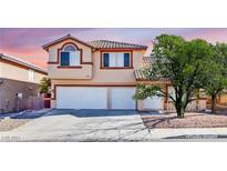 Two-story house with a two-car garage and landscaping at 1028 Twin Berry Ct, Henderson, NV 89002
