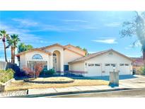 Two-story home with three car garage and landscaped yard at 2089 Avalon Dr, Laughlin, NV 89029