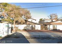 Exterior view of a two-story building with a carport and landscaping at 208 N Bruce St # C, Las Vegas, NV 89101