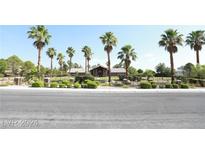 Ranch style home with palm trees and landscaping at 7650 Via Olivero Ave, Las Vegas, NV 89117