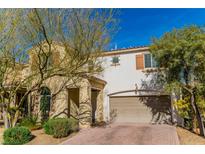 Beautiful two-story house with a tan exterior, two-car garage, and landscaping at 10622 Cliff Lake St, Las Vegas, NV 89179