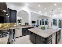 Gourmet kitchen with granite countertops and dark cabinetry at 7 Ayden Dr, Henderson, NV 89052