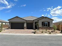 Modern two-car garage home with stone accents at 9166 Chandler Bloom Ct, Las Vegas, NV 89139