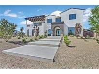 Stunning two-story home with a modern design and walkway at 9880 Dorrell Ln, Las Vegas, NV 89149