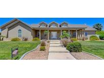 Two story house with front porch and manicured lawn at 1396 Lake Valley Dr, Logandale, NV 89021