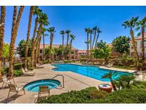 Inviting pool and spa area with lounge chairs, surrounded by lush landscaping at 700 Carnegie St # 2313, Henderson, NV 89052