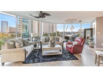 Spacious living room with city views, featuring comfortable seating and a grand piano at 322 Karen Ave # 408, Las Vegas, NV 89109