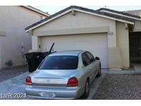House exterior with attached garage and a driveway at 8129 Backpacker Ct, Las Vegas, NV 89131