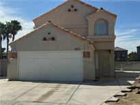 Two story house with attached garage and desert landscaping at 7101 Flowerridge Ln, Las Vegas, NV 89129