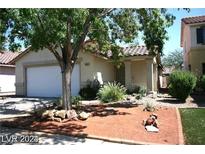 One-story house with a white garage door and landscaping at 9524 Kelly Creek Ave, Las Vegas, NV 89129