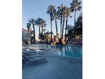 Inviting resort-style pool with palm trees and lounge chairs at , Las Vegas, NV 89117