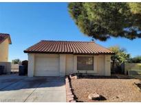Single story house with tile roof, attached garage and desert landscaping at 500 Prescott St, Las Vegas, NV 89110