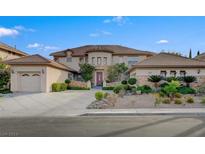 Two-story home with landscaped yard and attached garage at 10829 Ickworth Ct, Las Vegas, NV 89135