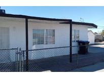 House exterior with a covered patio and chain link fence at 1316 Lawry Ave, Las Vegas, NV 89106