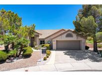 Single-story home with landscaped yard and attached garage at 9201 Cactus Wood Dr, Las Vegas, NV 89134