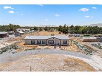 Aerial view of a single-story home with a yard and surrounding desert landscape at 4331 E Mcgraw Rd, Pahrump, NV 89061