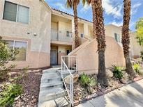 Two story condo building with palm trees and walkway at 5000 Red Rock St # 173, Las Vegas, NV 89118