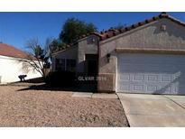 Single-story home with a two-car garage and desert landscaping at 733 Hitchen Post Dr, Henderson, NV 89011