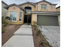 Two story house with attached garage at 3237 Perching Bird Ln, North Las Vegas, NV 89084