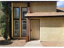 Tan two story condo with a sunburst door at 513 Kristin Ln, Henderson, NV 89011