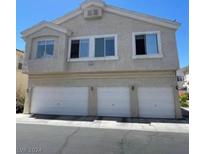 Two-story townhome with attached garage and front landscaping at 5969 High Steed St # 101, Henderson, NV 89011