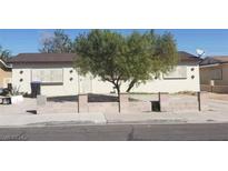 Single story house with a tree in the front yard at 1936 Lawry Ave, North Las Vegas, NV 89032