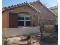 Single story house with brown shutters and landscaping at 7112 Whitford St, Las Vegas, NV 89166