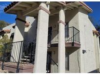 Two-story building exterior with covered entryway, stairs, and a balcony at 4451 Rich Dr # D, Las Vegas, NV 89102