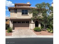 Two story home with tan siding, three car garage, and landscaping at 224 Crooked Putter Dr, Las Vegas, NV 89148