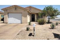 Single-story house with a white garage door and landscaped yard at 457 E Merlayne Dr, Henderson, NV 89011