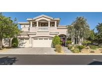 Two-story house with three-car garage and landscaping at 2981 Hammerwood Dr, Las Vegas, NV 89135