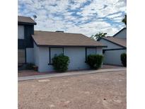 Tan colored house exterior with shrubs at 4009 Danford Pl # 1, Las Vegas, NV 89102